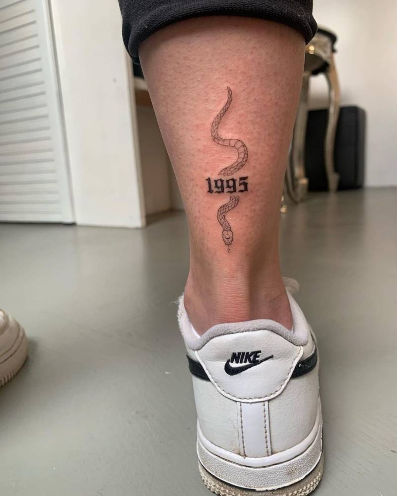 Fine line snake tattoo on the achilles.