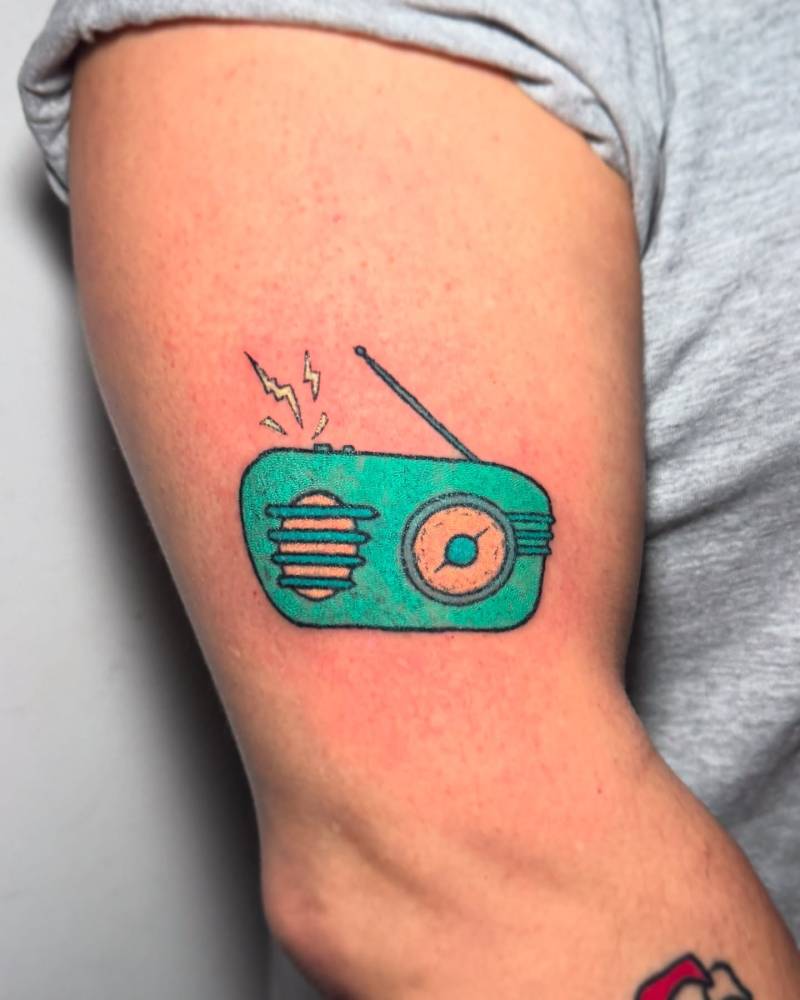 Hand poked style radio tattoo located on the upper arm.