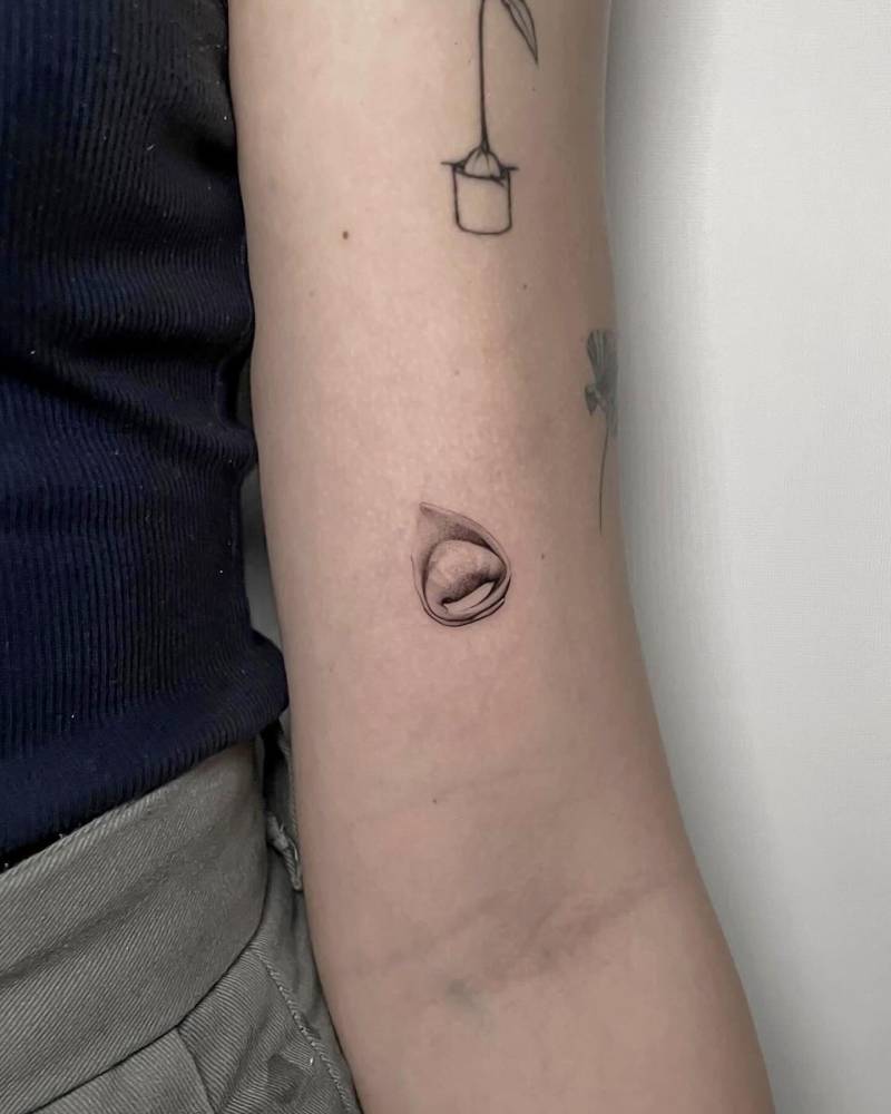 Micro-realistic style tortellini pasta tattoo located on the bicep.