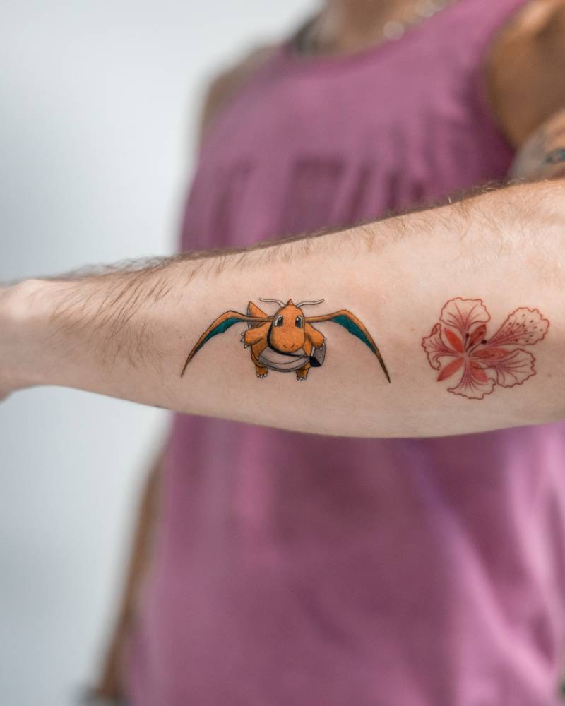 Cartoon style Dragonite tattoo placed on the forearm.