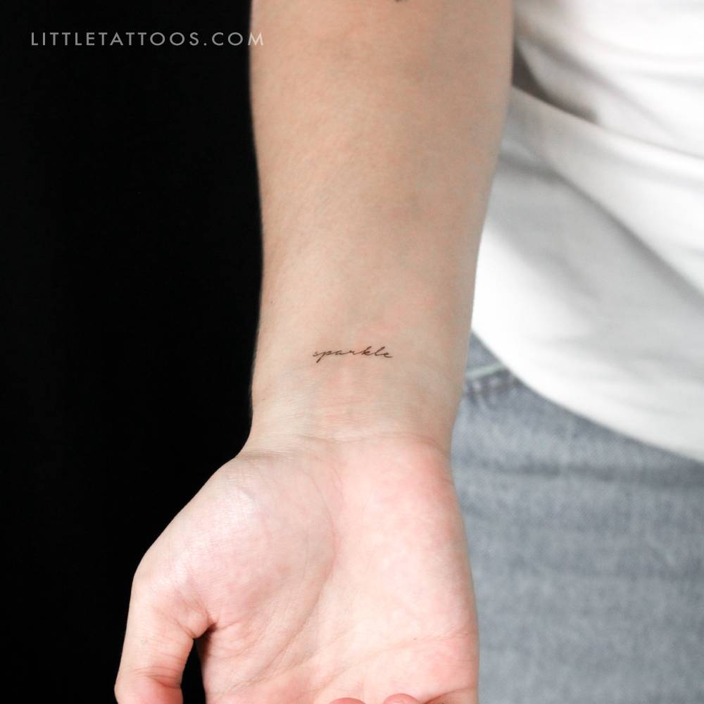 "Sparkle" temporary lettering tattoo located on the wrist.