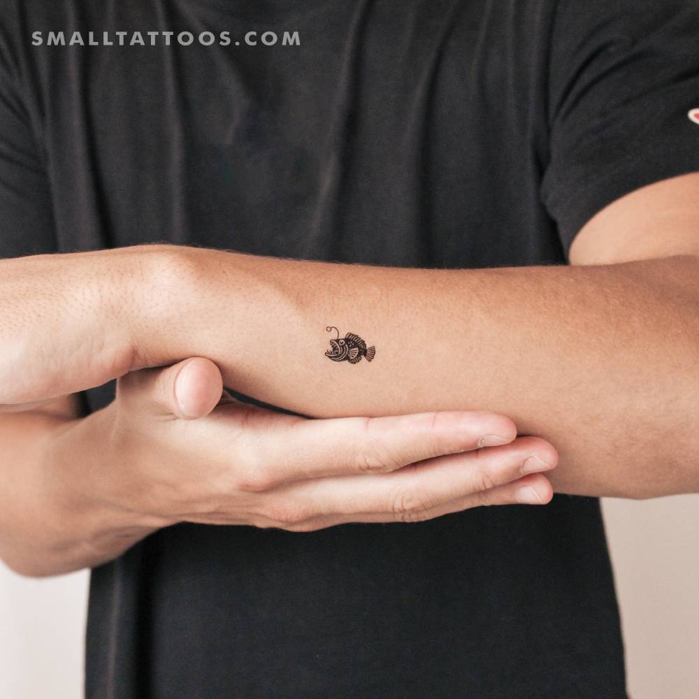 Illustrative style anglerfish temporary tattoo located on the wrist.