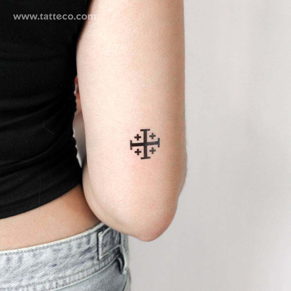 Jerusalem cross temporary tattoo placed on the tricep.