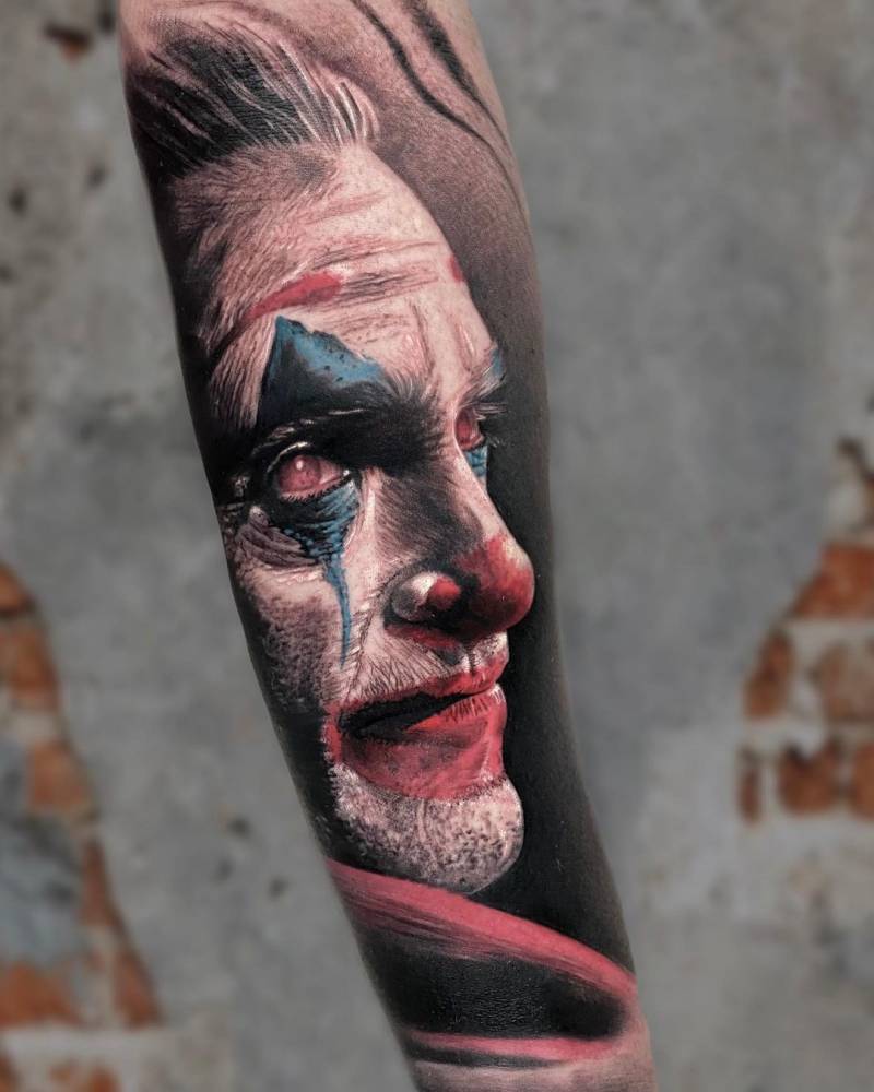 Realistic The Joker portrait tattoo located on the inner forearm.