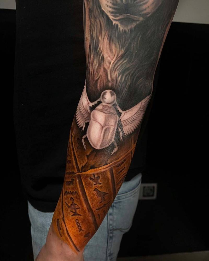 Realistic Egiptian Scarab themed sleeve tattoo.