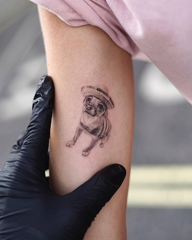 Micro-realistic chihuahua tattoo located on the inner arm.