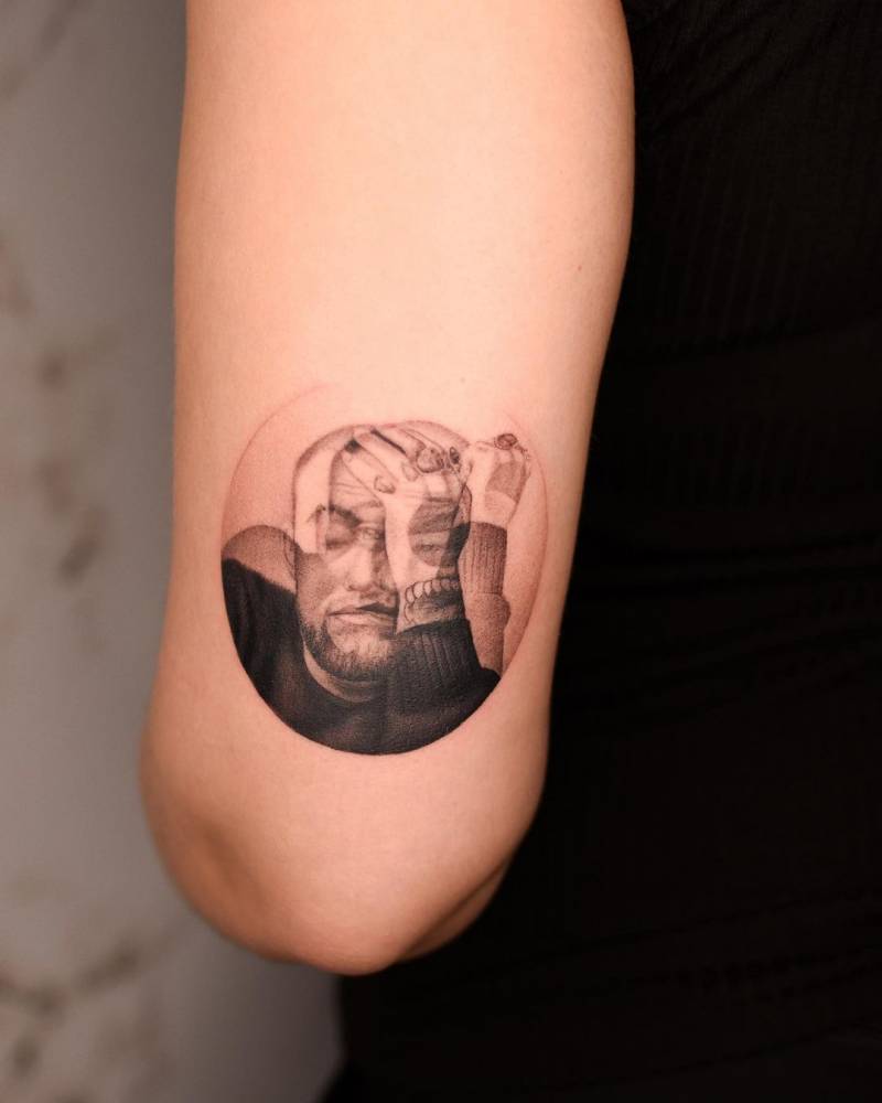 Blurry effect Mac Miller portrait tattoo located on the tricep.