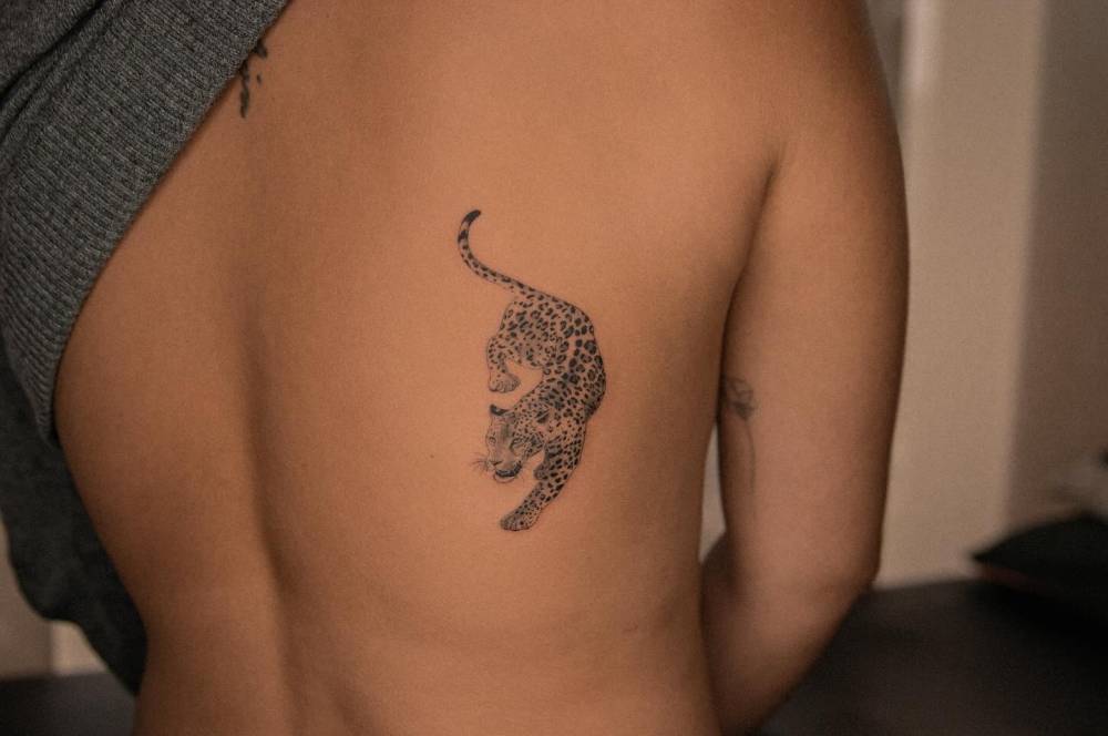 Micro-realistic style jaguar tattoo located on the back.