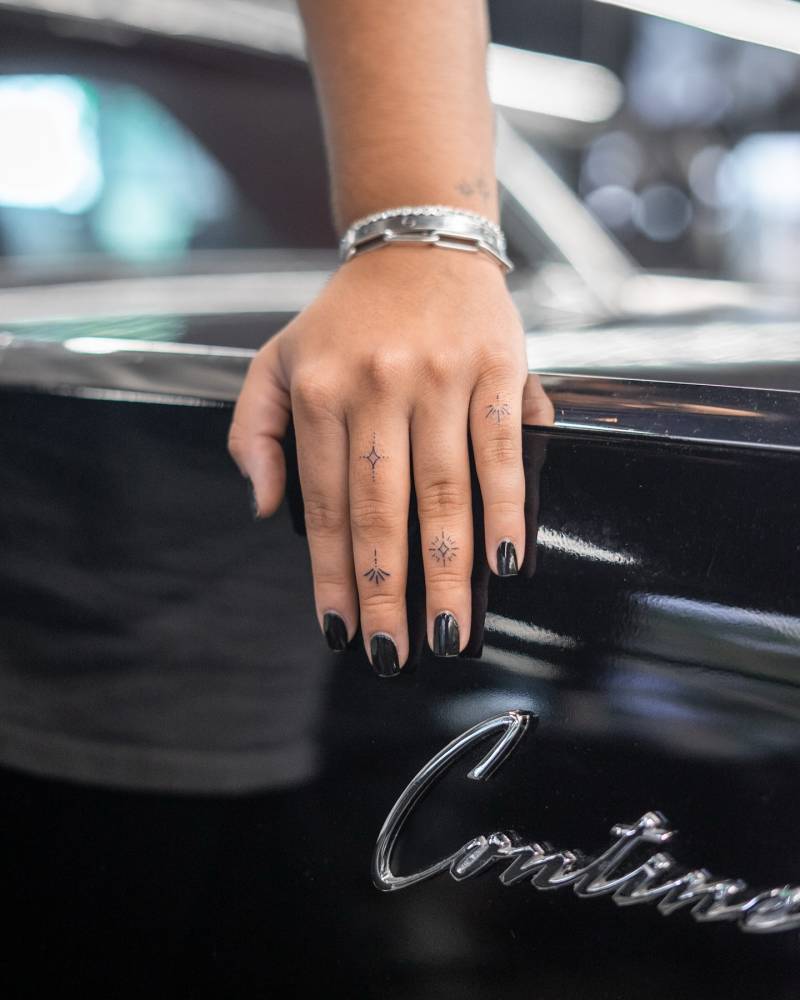 Fine line style ornamental finger composition tattoos.