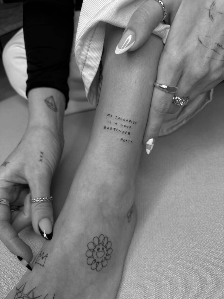 "My therapist is a good bartender" lettering tattoo located on the ankle.