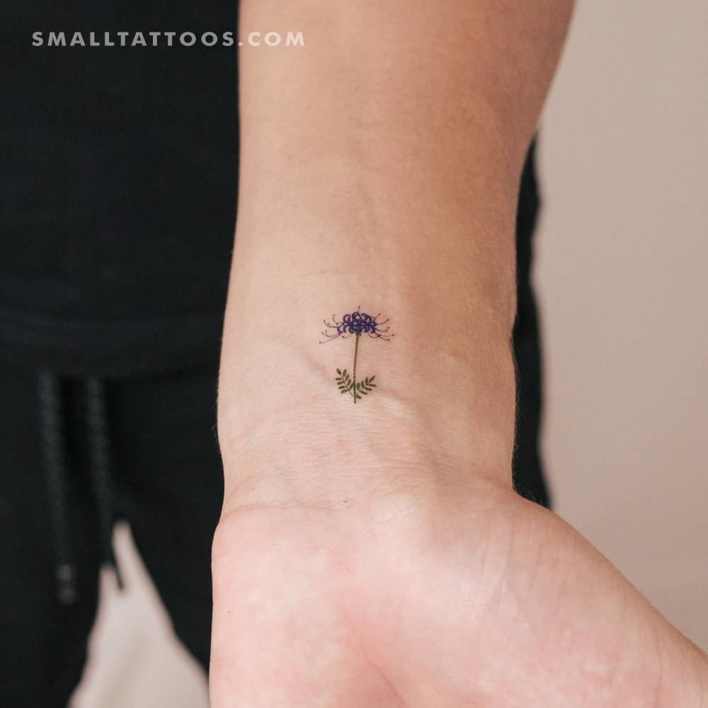 Blue spider lily temporary tattoo located on the wrist.