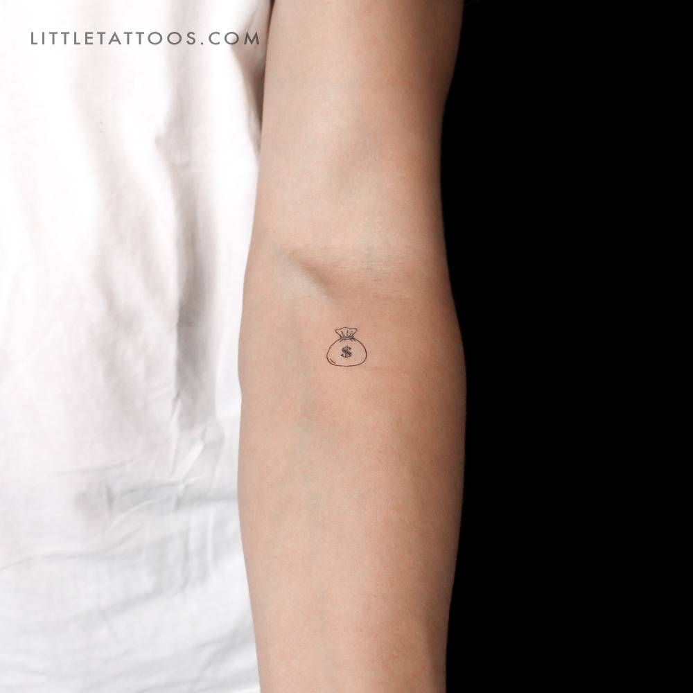 Minimalistic style money bag temporary tattoo located on the inner forearm.