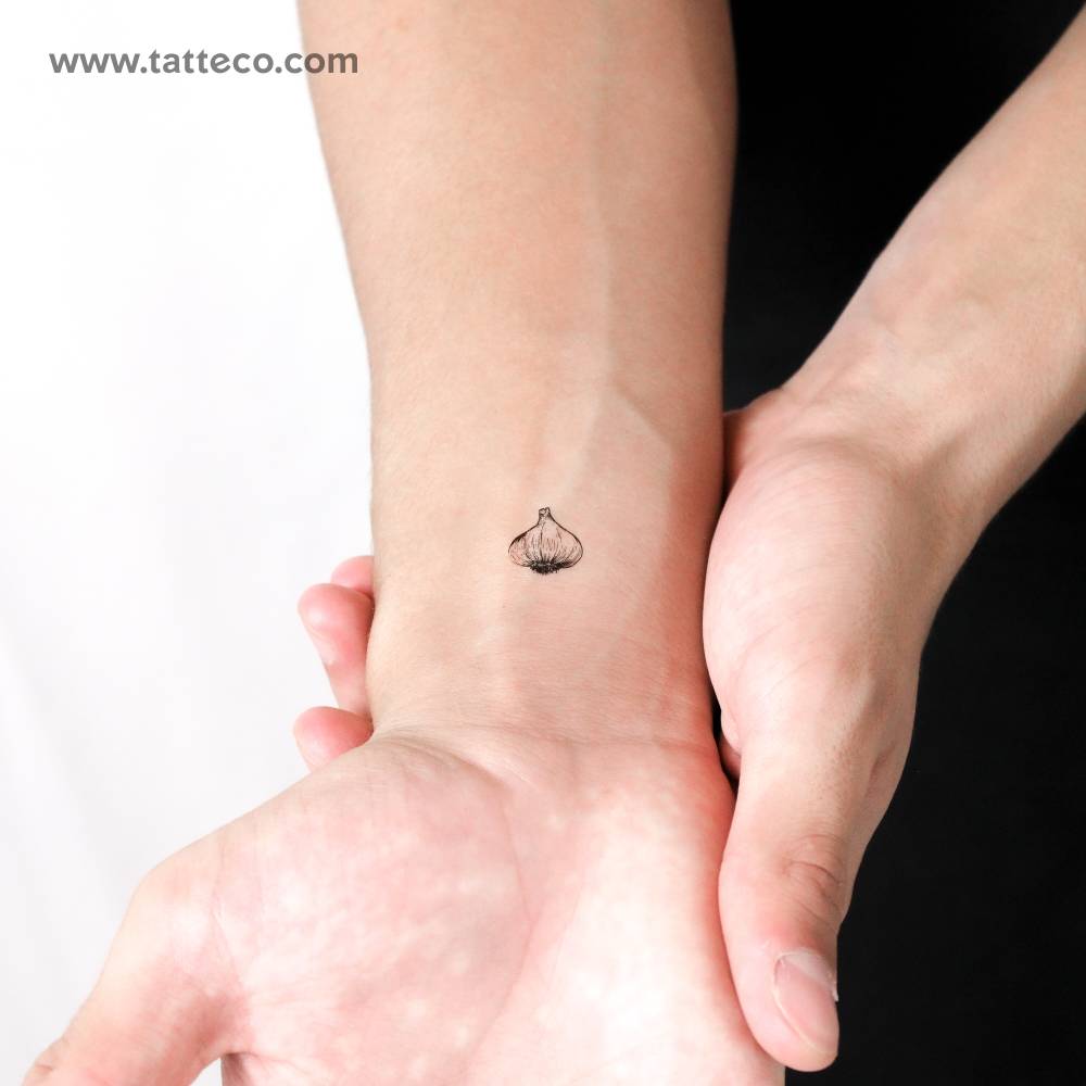Head of garlic temporary tattoo located on the wrist.
