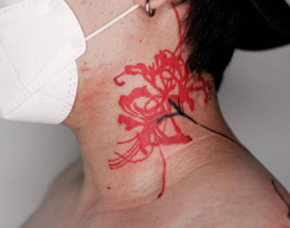 Red spider lily tattoo located on the neck.