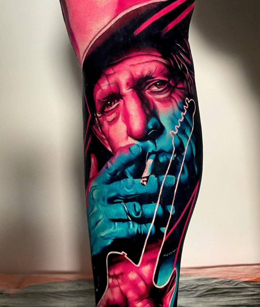 Keith Richards portrait tattooed on the shin.