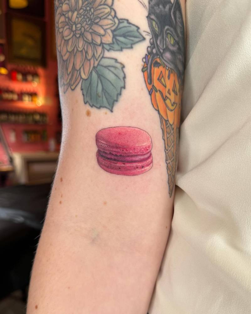 Realistic style macaron tattoo located on the bicep.