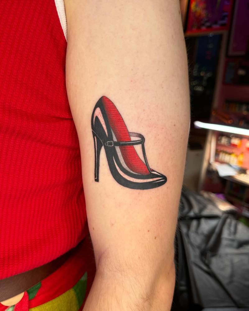 Traditional style high heel tattoo located on the upper arm.