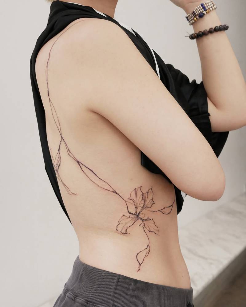 Huge iris flower tattoo done in sketch work style.