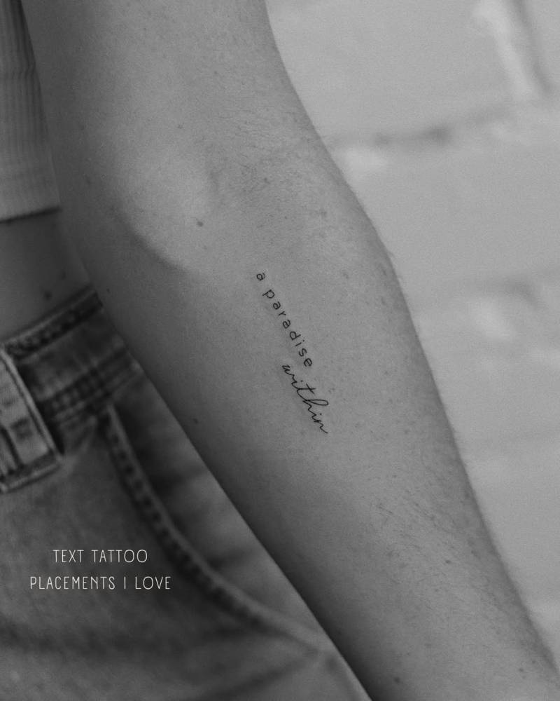 "A paradise within" lettering tattoo located on the inner forearm.