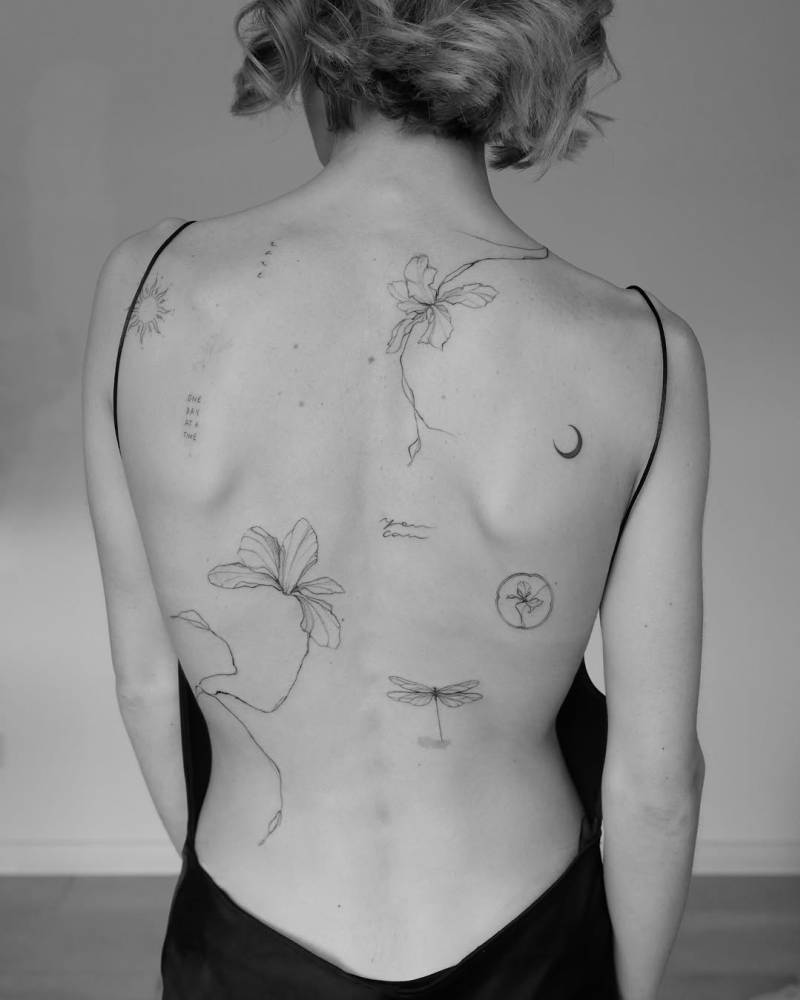 Illustrative style back composition tattoos.