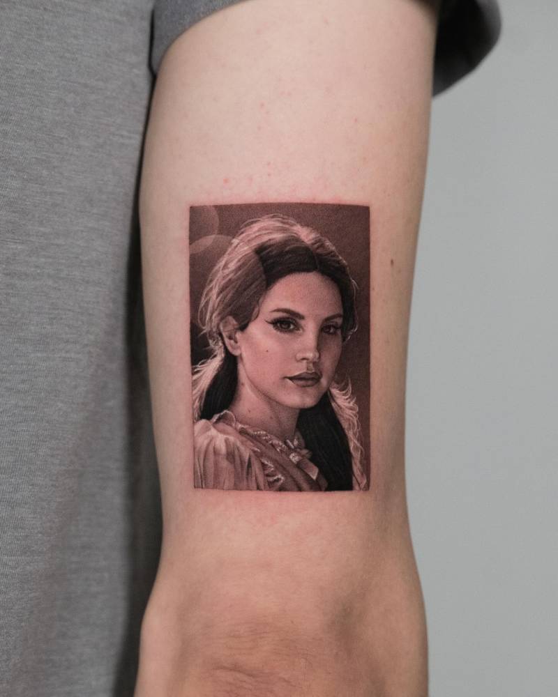 Lana Del Rey portrait tattoo located on the tricep, done in micro-realism.
