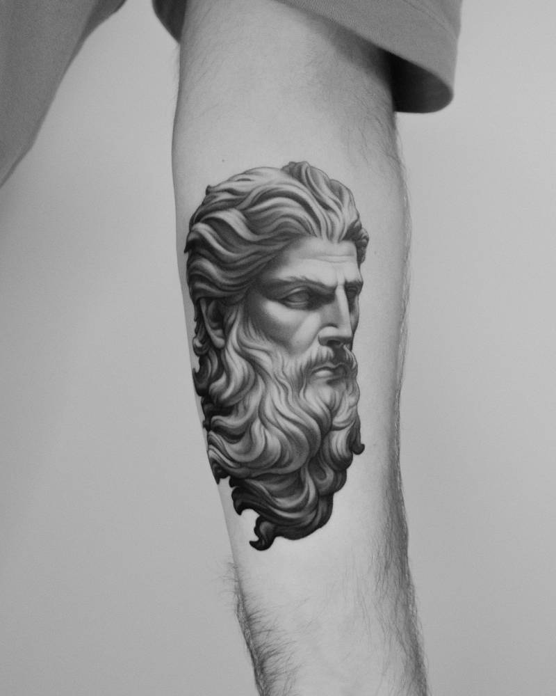Zeus portrait tattoo in micro-realism located on the inner forearm.