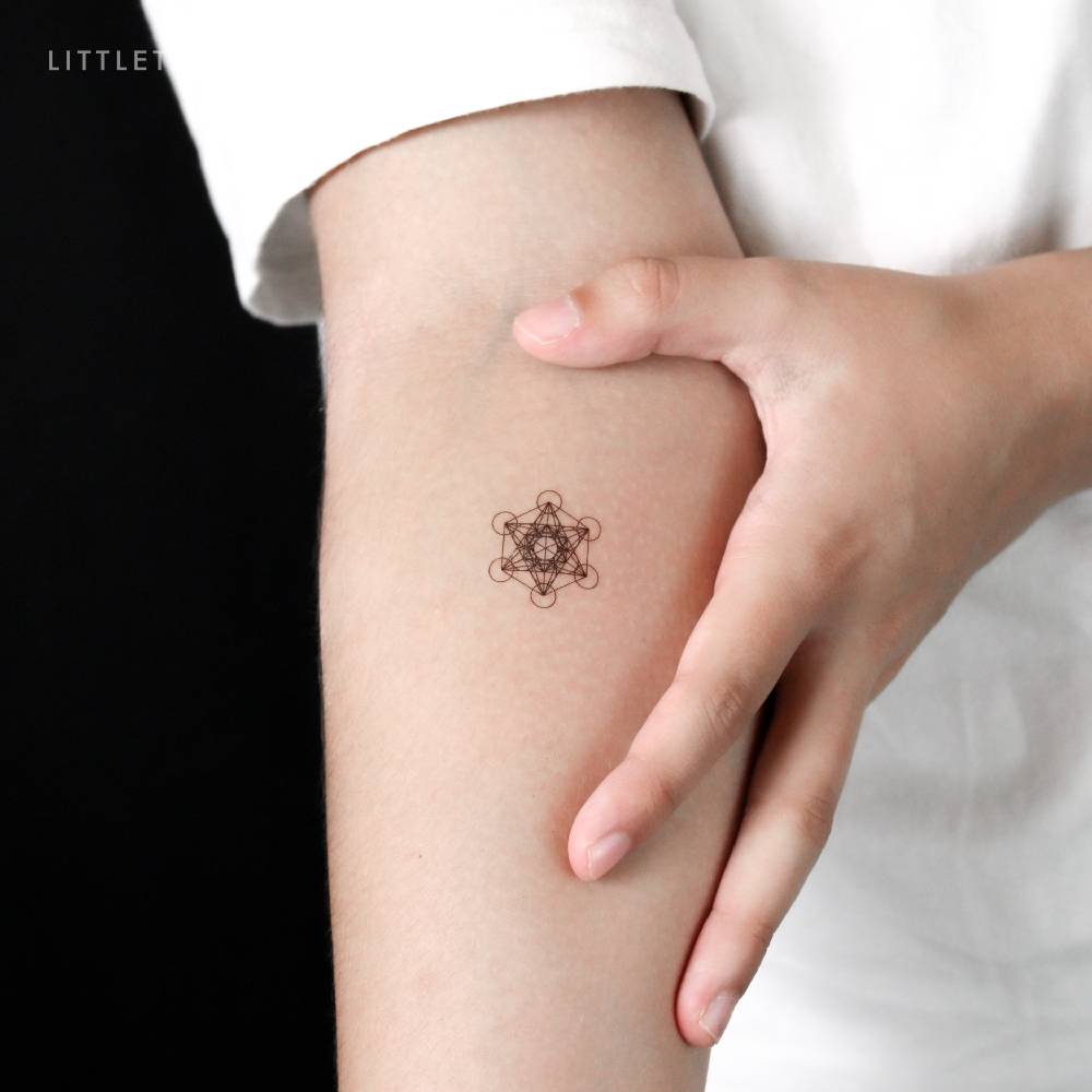 Small Metatron's cube temporary tattoo located on the inner forearm.