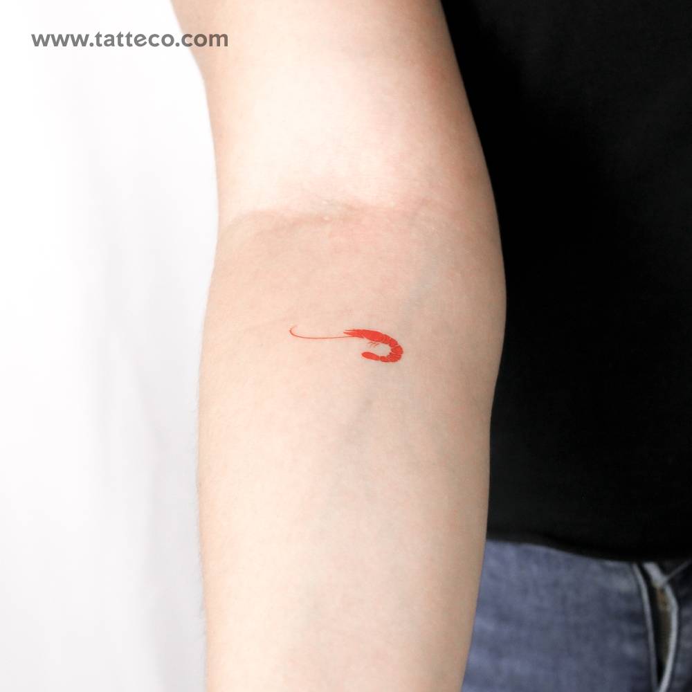 Red prawn temporary tattoo located on the inner forearm.