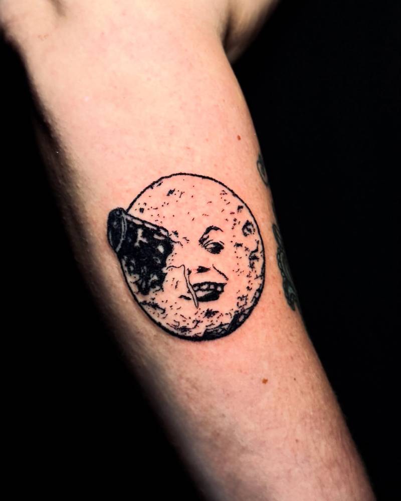 'A Trip to the Moon' tattoo located on the forearm.