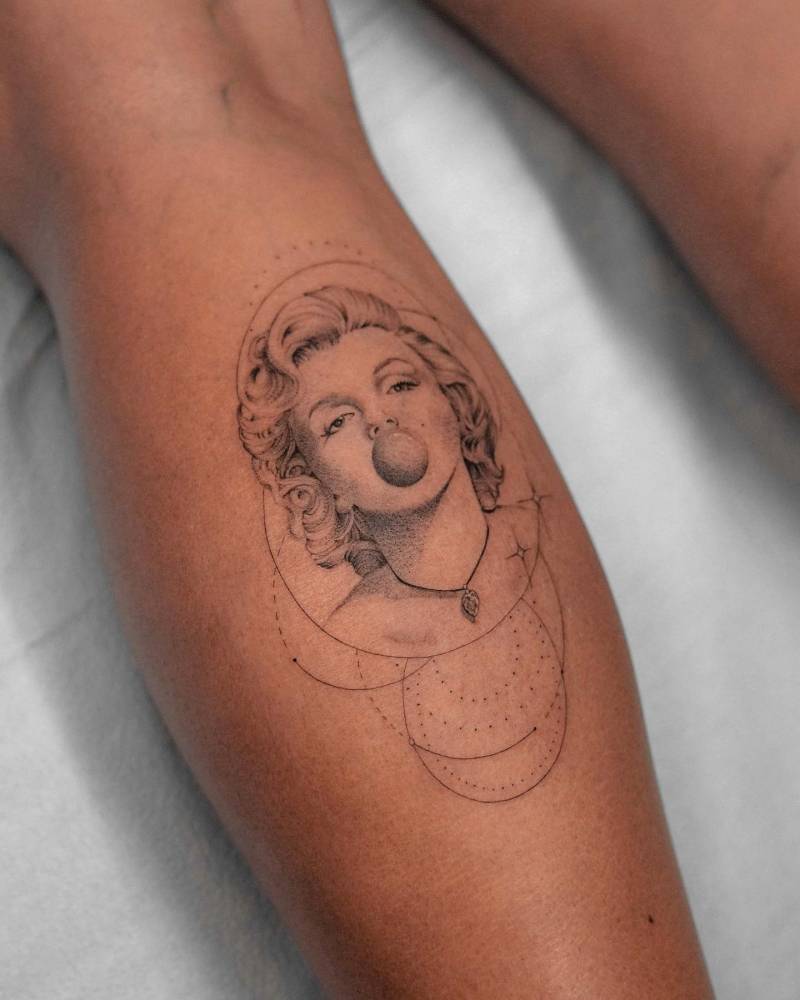 Micro-realistic style Marilyn Monroe portrait tattoo located on the calf.