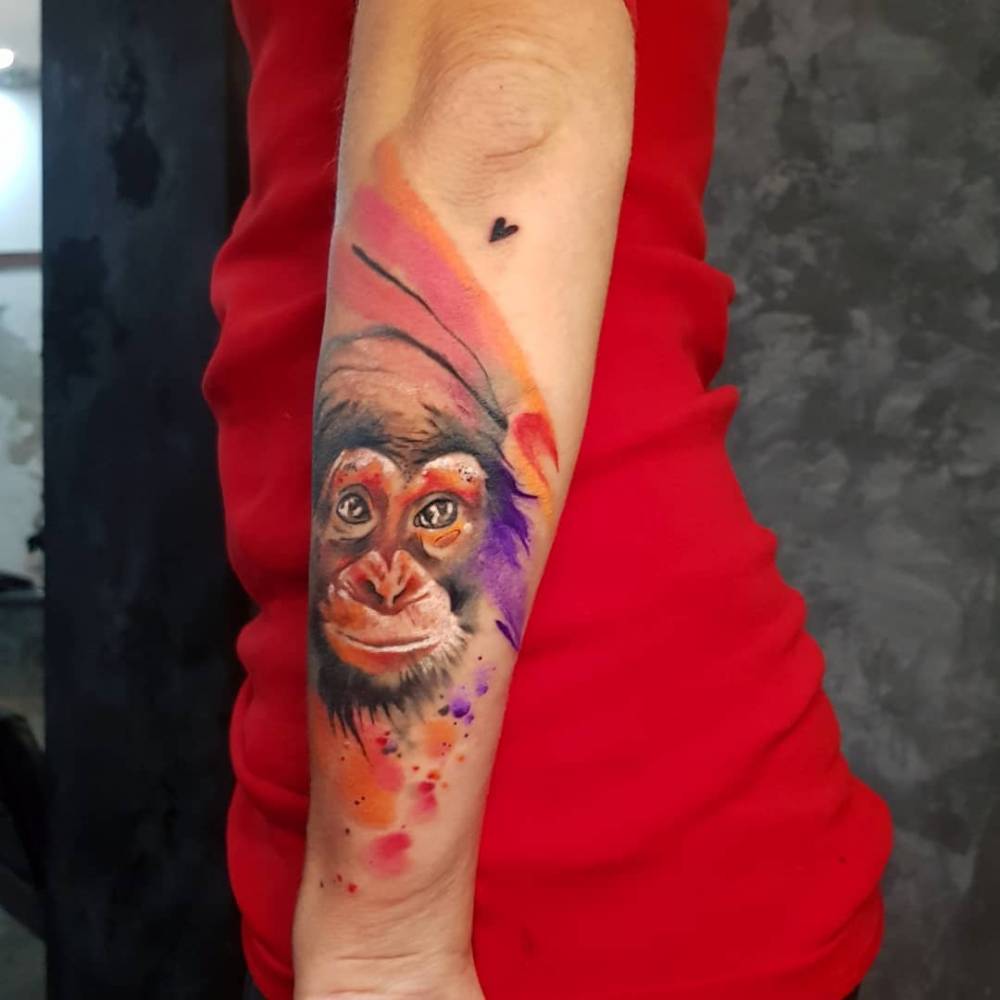 Chimp tattoo done on the forearm, watercolor style.