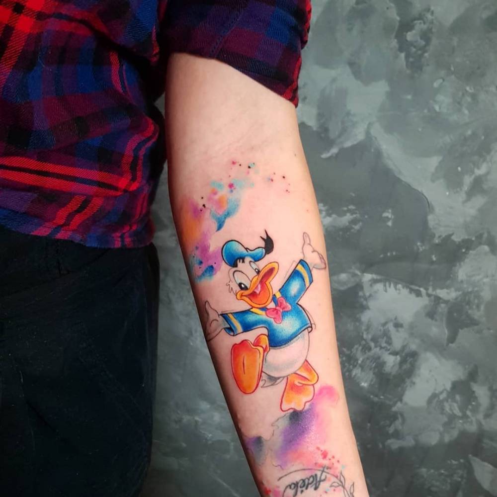 Donald Duck tattoo located on the inner forearm.