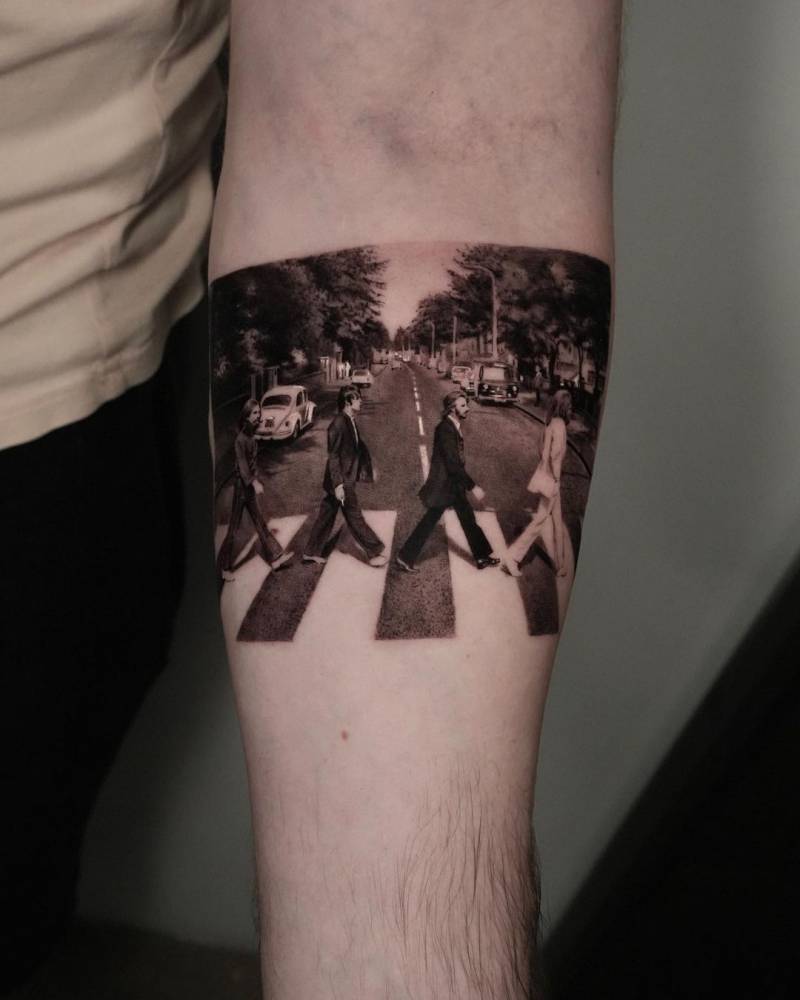Abbey Road album cover tattoo located on the inner forearm.