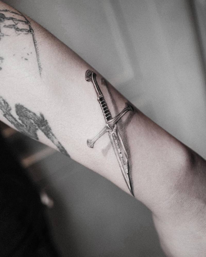 'The Lord Of The Rings' sword tattoo located on the wrist.