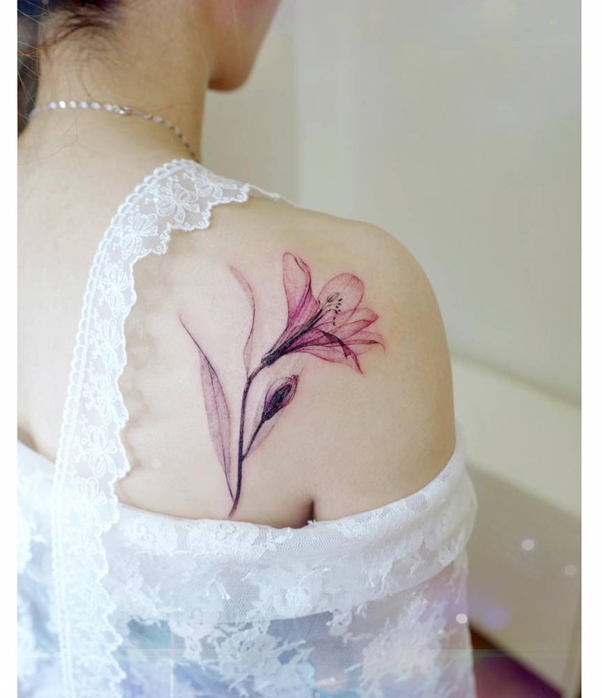 X-Ray lily flower tattoo located on the shoulder blade.
