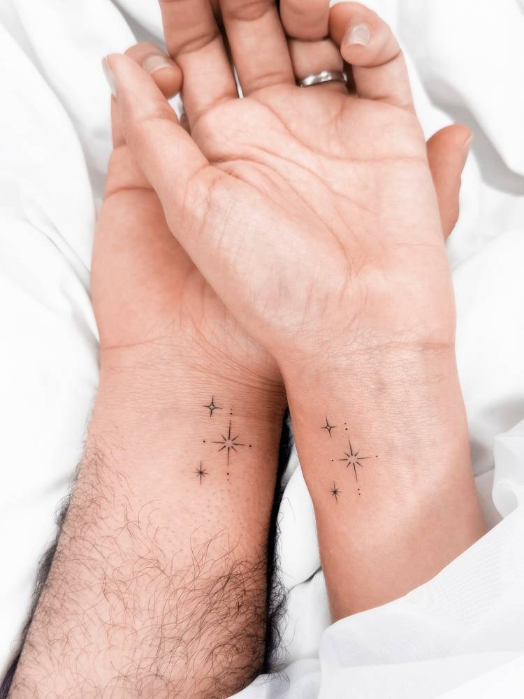 Matching sparkling stars tattoo for couple.