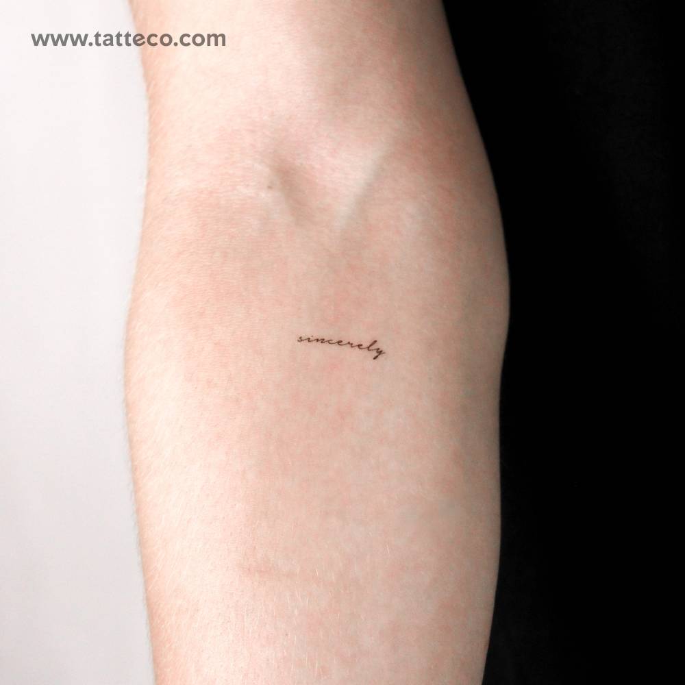 Word "sincerely" temporary tattoo located on the inner forearm.