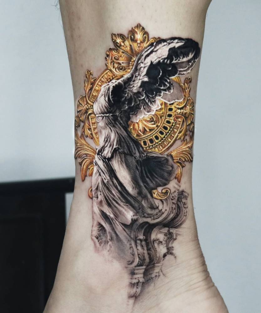 Nike of Samothrace tattoo located on the ankle, micro-realistic style.