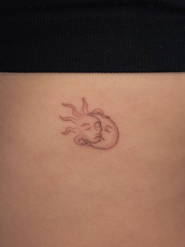 Single needle kissing sun and moon tattoo located on the rib.