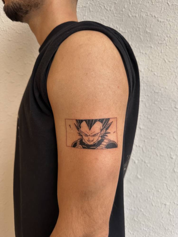 Dragon Ball's Vegeta portrait tattoo placed on the upper arm.