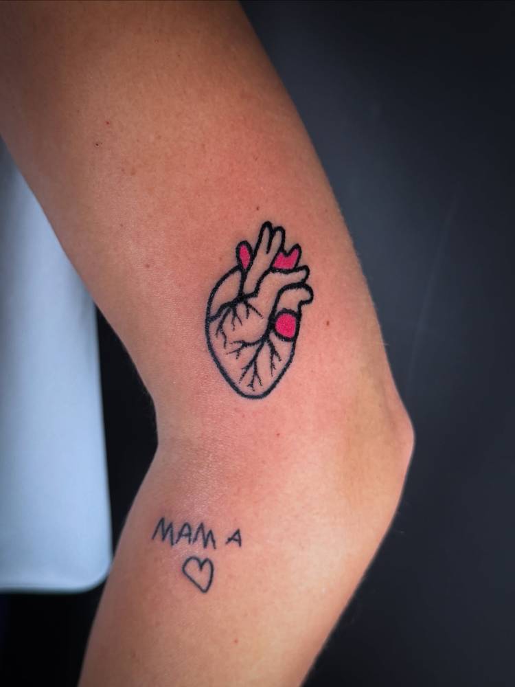 Anatomical heart tattoo hand poked on the upper arm.