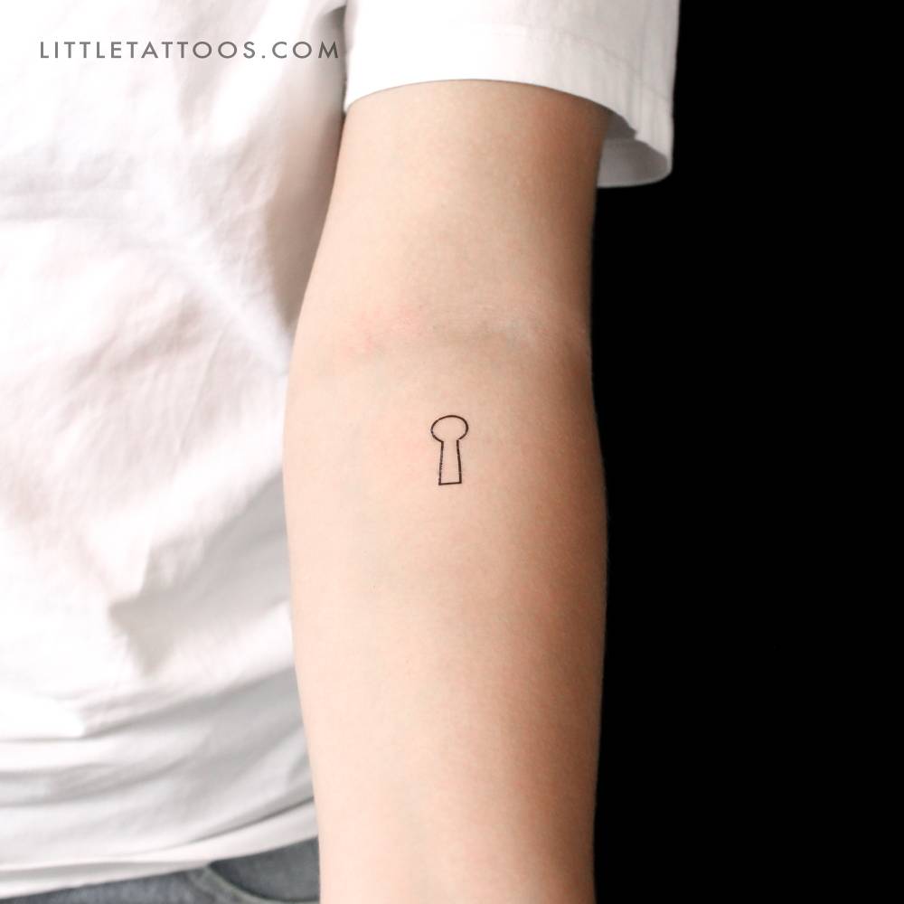 Minimalistic style keyhole outline temporary tattoo located on the inner forearm.