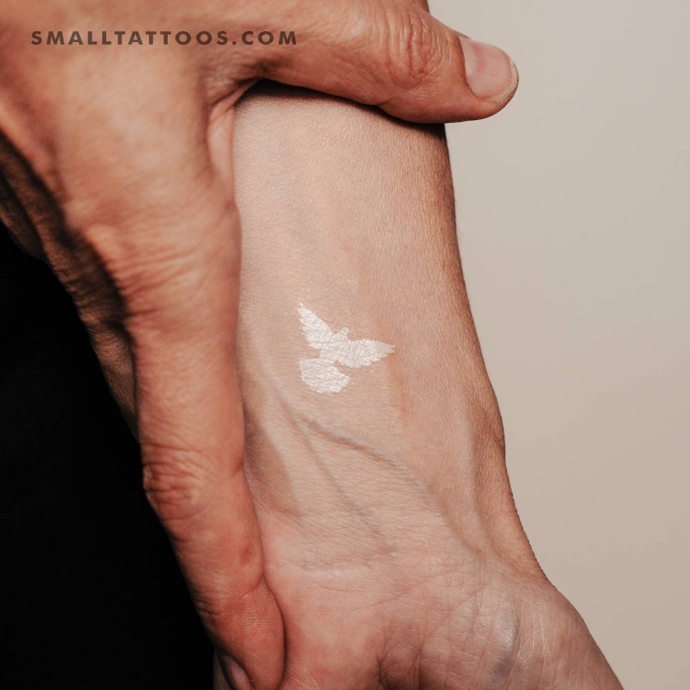 White dove temporary tattoo placed on the wrist.