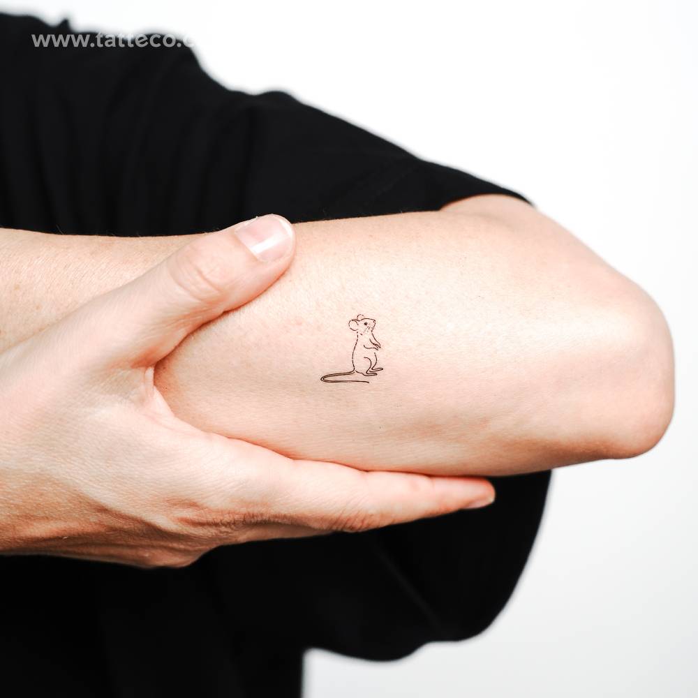 Fine line style standing mouse temporary tattoo located on the forearm.