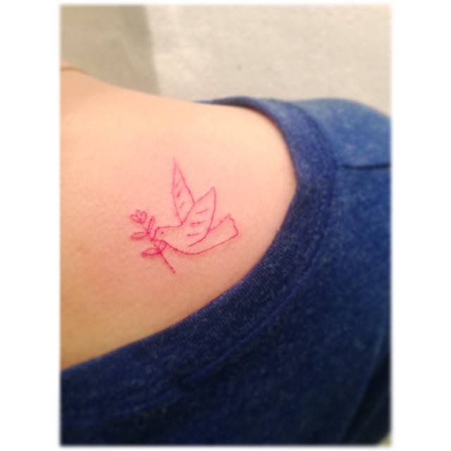 Dove of peace tattoo located on the shoulder blade.