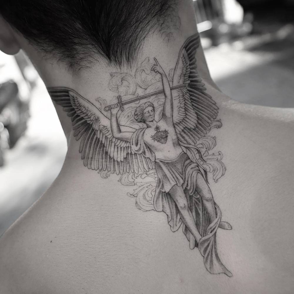 Illustrative style angel tattoo located on the back of the neck.