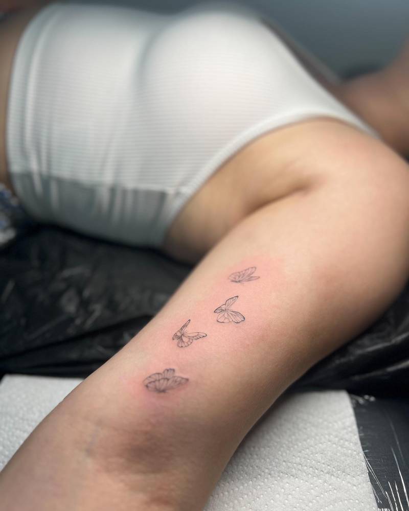 Single needle butterflies tattoo located on the inner arm.