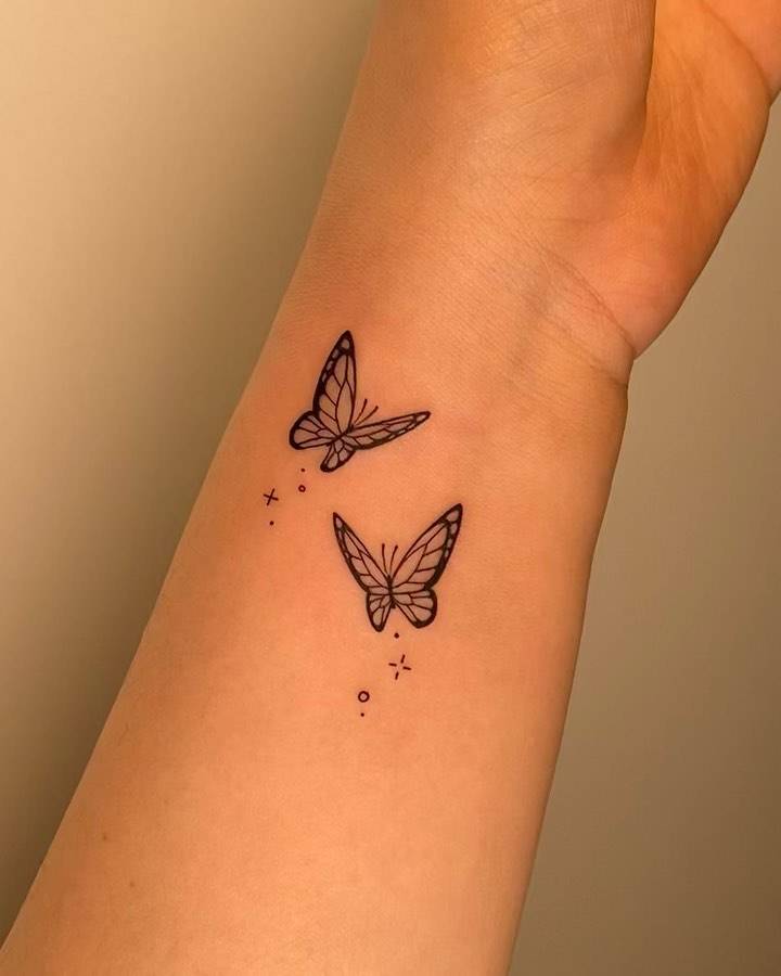 Butterfly couple tattoo located on the wrist.