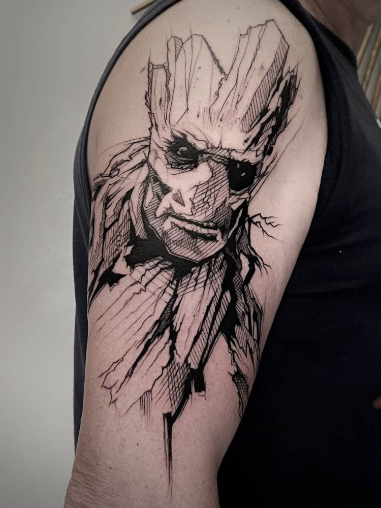 Sketch work style Groot portrait tattoo located on the upper arm.