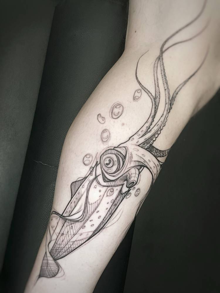 Squid tattoo in sketch work style placed on the shin.